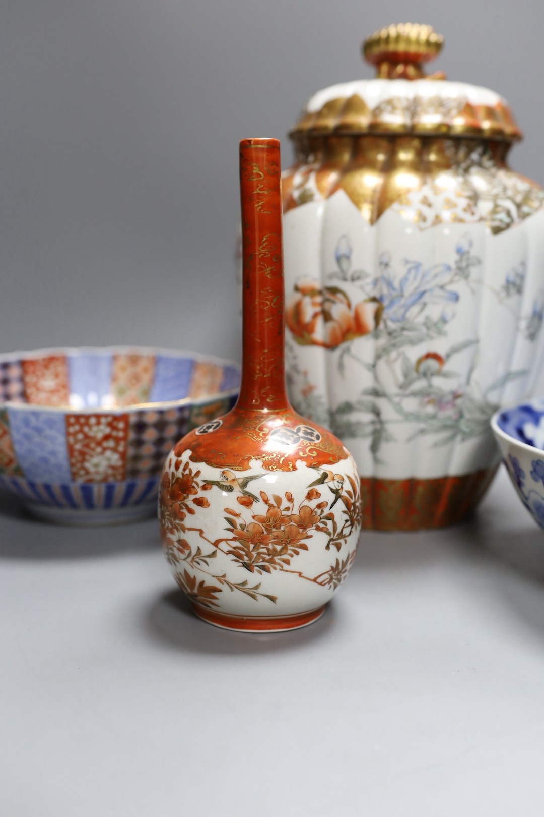 A Japanese kutani bottle vase, similar vase and cover (a.f), an Imari bowl and blue and white bowl. Largest 27cm